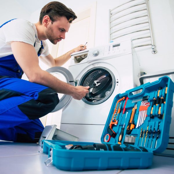 young-handsome-repairman-worker-suit-with-professional-tools-box-is-fixing-washing-machine-bathroom (1)